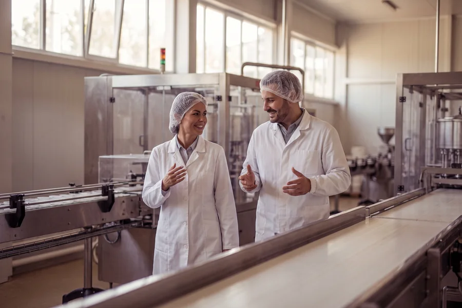 Quality team walking a clean production hall during an audit